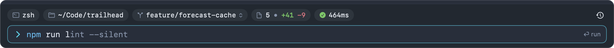 The input bar: chips for the shell, ~/Code/trailhead, feature/forecast-cache, 5 changed files and the last command's status, above a command with a ghost suggestion